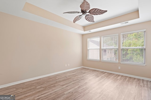 111 Moonlight Trl, Port Wentworth, GA 31407 - empty room featuring a raised ceiling, light wood-style floors, baseboards, and ceiling fan