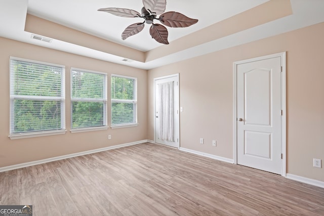 111 Moonlight Trl, Port Wentworth, GA 31407 - unfurnished bedroom with light wood-type flooring, baseboards, multiple windows, and a raised ceiling