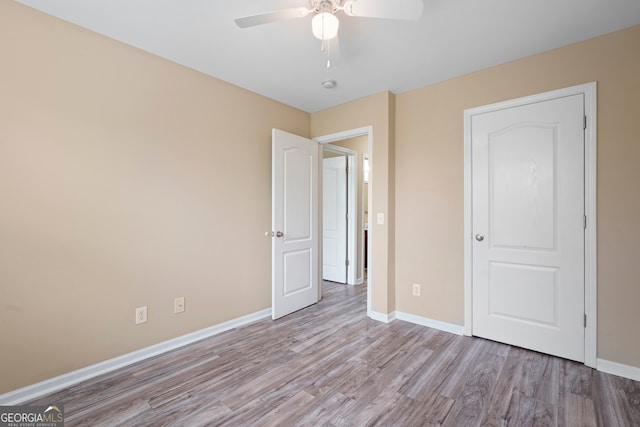 111 Moonlight Trl, Port Wentworth, GA 31407 - unfurnished bedroom with wood finished floors, baseboards, and a ceiling fan