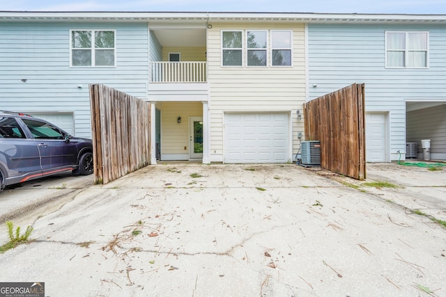 111 Moonlight Trl, Port Wentworth, GA 31407 - rear view of house featuring central AC, an attached garage, and concrete driveway
