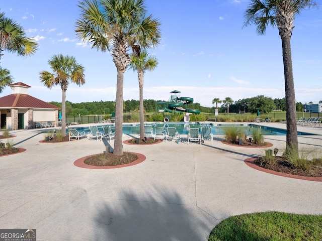 111 Moonlight Trl, Port Wentworth, GA 31407 - community pool featuring a water slide and a patio