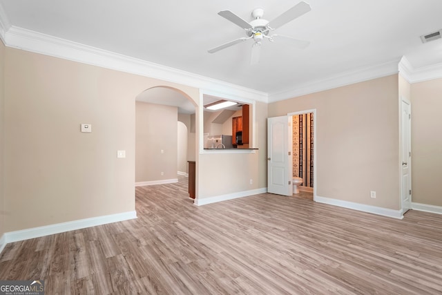 111 Moonlight Trl, Port Wentworth, GA 31407 - unfurnished living room with light wood-style flooring, a ceiling fan, arched walkways, ornamental molding, and baseboards
