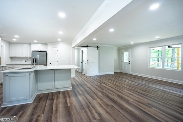 2265 Mobley Bridge Rd, Hogansville, GA 30230 - kitchen featuring a barn door, stainless steel fridge with ice dispenser, ornamental molding, open floor plan, and dark wood-style floors