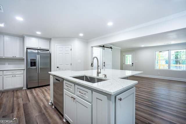 2265 Mobley Bridge Rd, Hogansville, GA 30230 - kitchen with stainless steel appliances, a barn door, crown molding, dark wood finished floors, and open floor plan