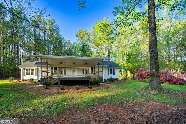 2265 Mobley Bridge Rd, Hogansville, GA 30230 - back of house featuring a ceiling fan, a deck, and a yard