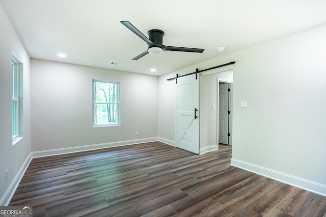 2265 Mobley Bridge Rd, Hogansville, GA 30230 - unfurnished bedroom featuring a barn door, wood finished floors, recessed lighting, and ceiling fan