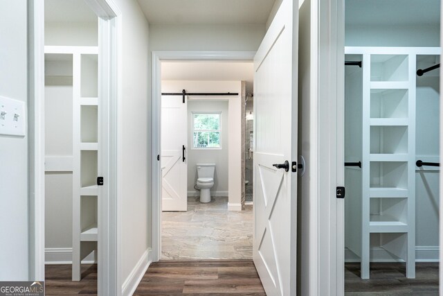 2265 Mobley Bridge Rd, Hogansville, GA 30230 - hallway featuring dark wood finished floors and a barn door