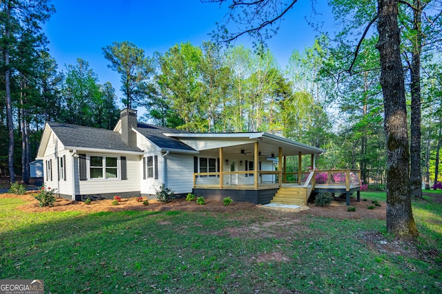 2265 Mobley Bridge Rd, Hogansville, GA 30230 - view of front of house featuring a chimney, a front lawn, a ceiling fan, and covered porch