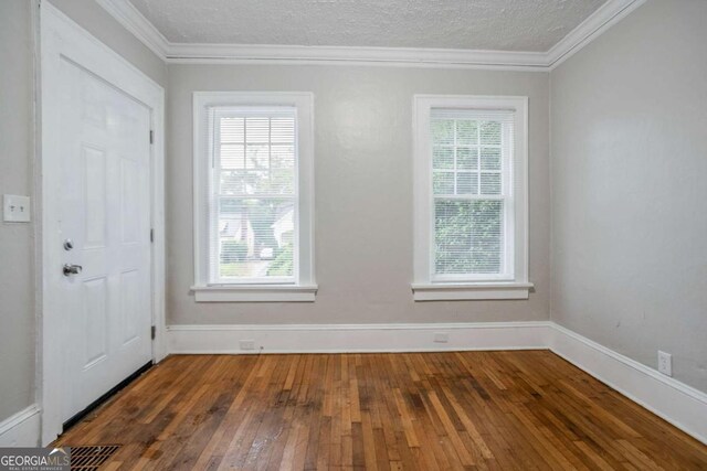 1615 Stokes Ave SW, Atlanta, GA 30310 - foyer entrance featuring healthy amount of natural light, hardwood / wood-style floors, ornamental molding, and a textured ceiling