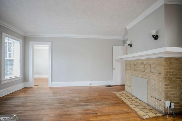 1615 Stokes Ave SW, Atlanta, GA 30310 - unfurnished living room featuring light wood finished floors, a textured ceiling, and ornamental molding