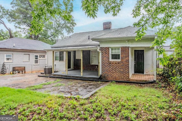 1615 Stokes Ave SW, Atlanta, GA 30310 - rear view of house with a patio area, a chimney, and brick siding