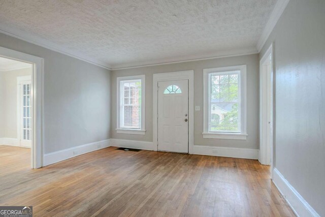 1615 Stokes Ave SW, Atlanta, GA 30310 - entryway featuring light wood-style flooring, ornamental molding, and a textured ceiling