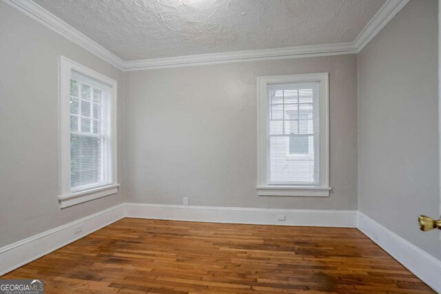 1615 Stokes Ave SW, Atlanta, GA 30310 - unfurnished room with wood finished floors, a textured ceiling, and ornamental molding