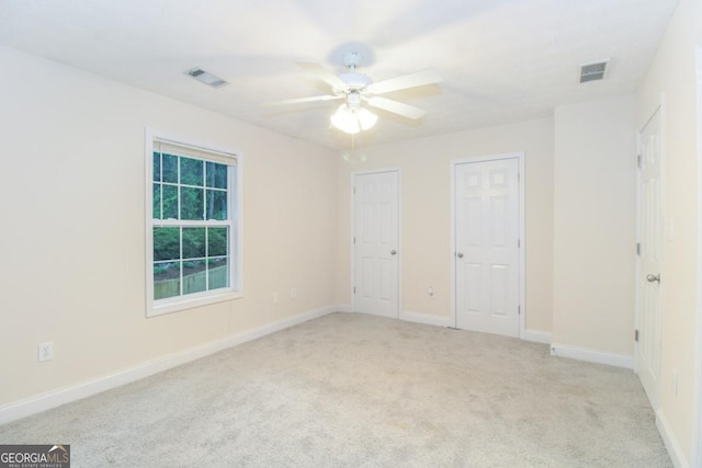 105 Westchester Dr Unit C4, Athens, GA 30606 - unfurnished bedroom with light carpet, multiple closets, baseboards, and ceiling fan