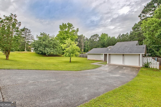 10 1st Ave E, Newnan, GA 30265 - view of front of house featuring driveway, a garage, view of wooded area, and roof with shingles