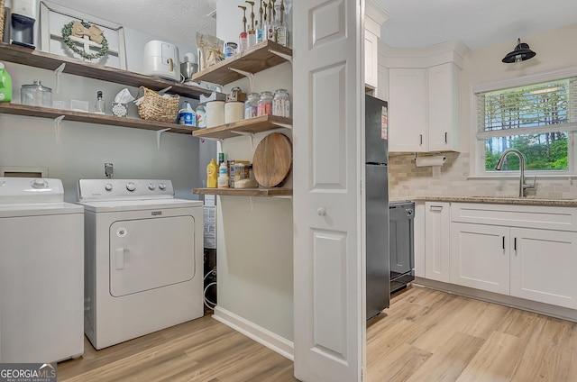 10 1st Ave E, Newnan, GA 30265 - laundry area featuring light wood-type flooring and separate washer and dryer