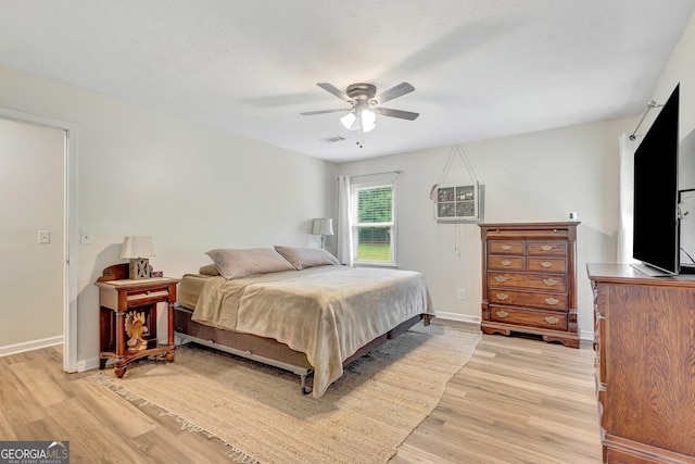 10 1st Ave E, Newnan, GA 30265 - bedroom with light wood-style floors, baseboards, and a ceiling fan