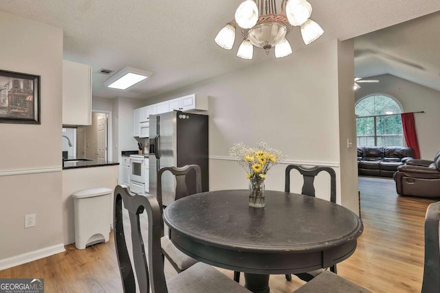 40 Moore Rd, Newnan, GA 30263 - dining area with a chandelier, light wood-type flooring, lofted ceiling, a ceiling fan, and baseboards