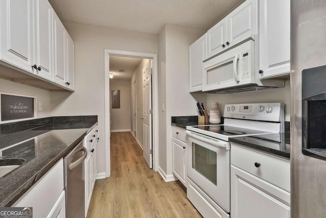 40 Moore Rd, Newnan, GA 30263 - kitchen with appliances with stainless steel finishes, white cabinetry, light wood-style floors, and dark stone counters