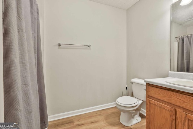 40 Moore Rd, Newnan, GA 30263 - full bath featuring vanity, wood finished floors, toilet, baseboards, and a shower with shower curtain