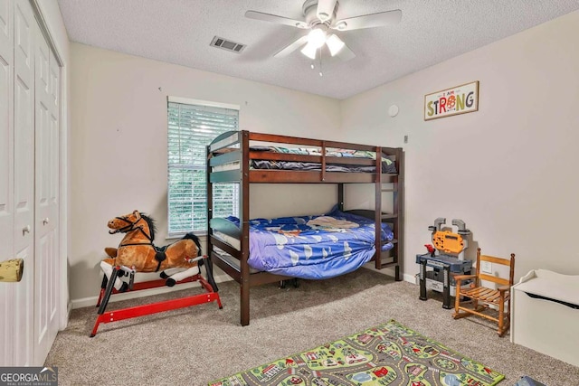 40 Moore Rd, Newnan, GA 30263 - carpeted bedroom featuring a textured ceiling, a closet, ceiling fan, and baseboards