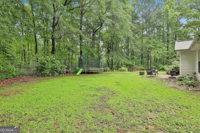 40 Moore Rd, Newnan, GA 30263 - view of yard featuring a trampoline, an outdoor fire pit, and a patio