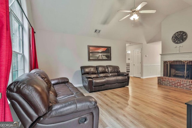 40 Moore Rd, Newnan, GA 30263 - living room featuring ceiling fan, light wood-type flooring, vaulted ceiling, baseboards, and a brick fireplace