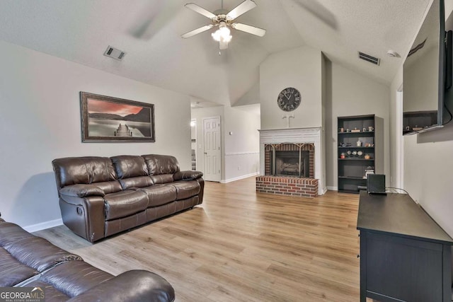 40 Moore Rd, Newnan, GA 30263 - living area featuring ceiling fan, lofted ceiling, a fireplace, light wood-type flooring, and baseboards