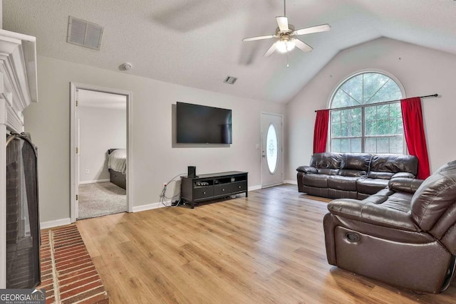 40 Moore Rd, Newnan, GA 30263 - living room with a ceiling fan, light wood-style floors, lofted ceiling, a fireplace, and baseboards