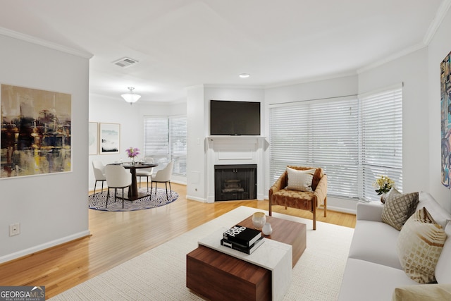 209 14th St NE Unit 109, Atlanta, GA 30309 - living area featuring ornamental molding, wood finished floors, a fireplace, and recessed lighting