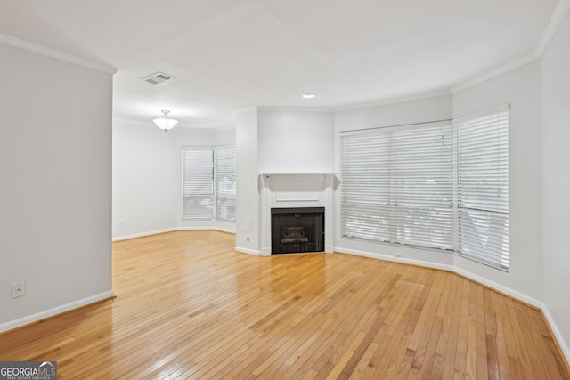 209 14th St NE Unit 109, Atlanta, GA 30309 - unfurnished living room with crown molding, light wood-style flooring, a fireplace, and recessed lighting
