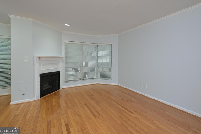 209 14th St NE Unit 109, Atlanta, GA 30309 - unfurnished living room featuring a fireplace, ornamental molding, wood-type flooring, and recessed lighting
