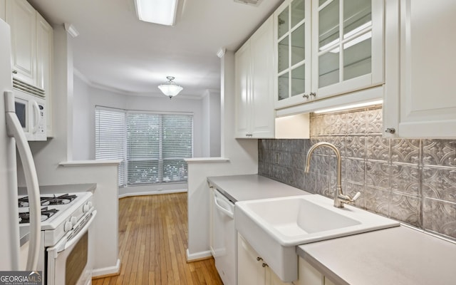 209 14th St NE Unit 109, Atlanta, GA 30309 - kitchen with white appliances, tasteful backsplash, glass insert cabinets, white cabinetry, and light wood-type flooring