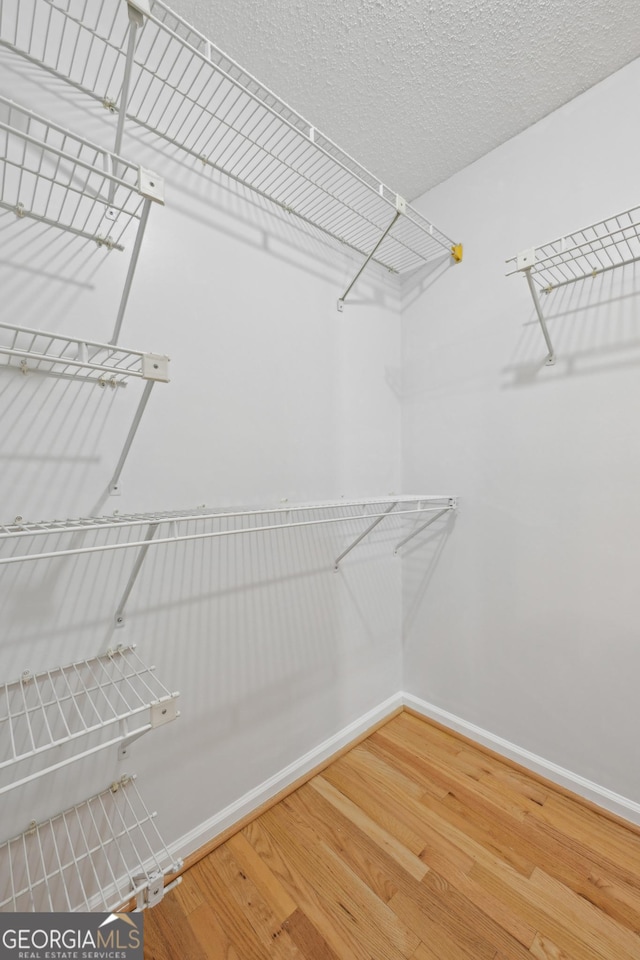 209 14th St NE Unit 109, Atlanta, GA 30309 - walk in closet with wood finished floors