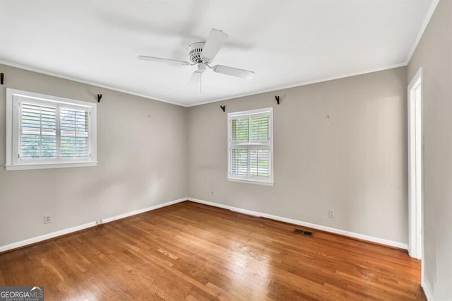 8140 Wood St SE, Covington, GA 30014 - spare room featuring ornamental molding, wood finished floors, baseboards, and ceiling fan