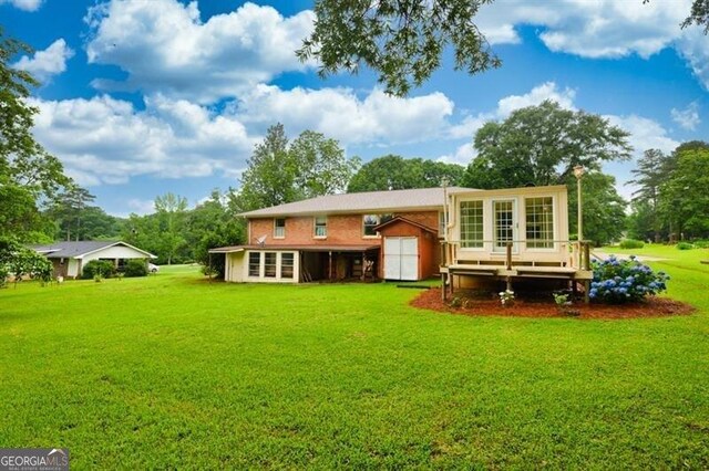 8140 Wood St SE, Covington, GA 30014 - rear view of house featuring a lawn and a deck