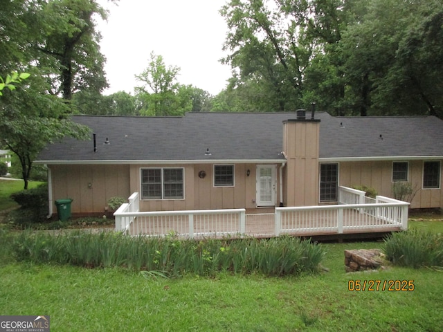5848 Navarre Ct, Stone Mountain, GA 30087 - back of property with a chimney, a wooden deck, board and batten siding, and a yard