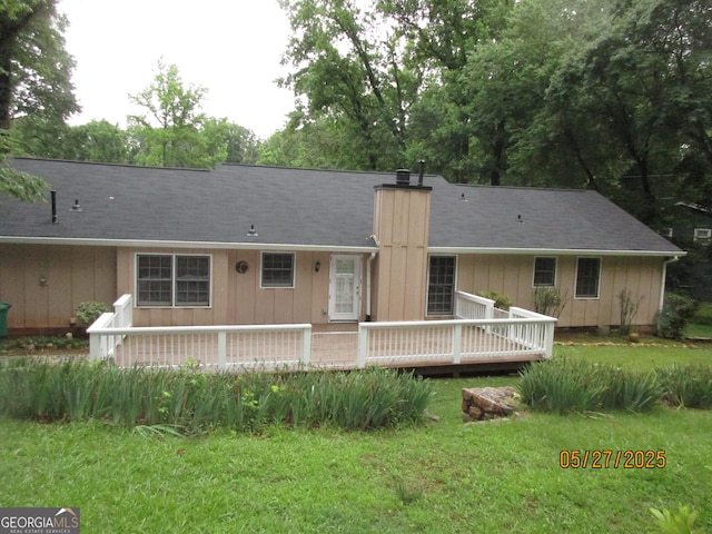 5848 Navarre Ct, Stone Mountain, GA 30087 - back of house with a chimney, a deck, a yard, and board and batten siding