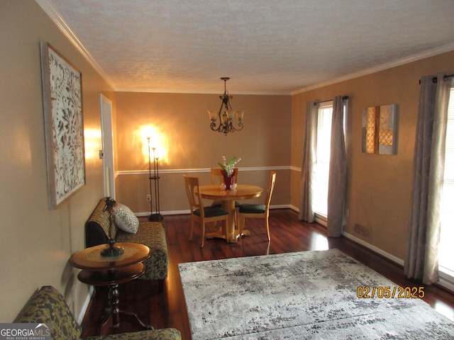 5848 Navarre Ct, Stone Mountain, GA 30087 - dining room with crown molding, wood finished floors, a chandelier, baseboards, and a textured ceiling