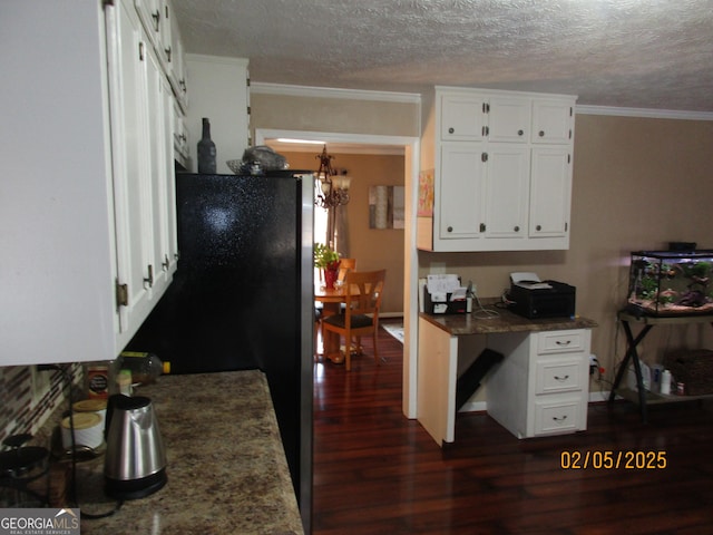 5848 Navarre Ct, Stone Mountain, GA 30087 - kitchen featuring dark wood-type flooring, white cabinetry, a textured ceiling, ornamental molding, and a chandelier