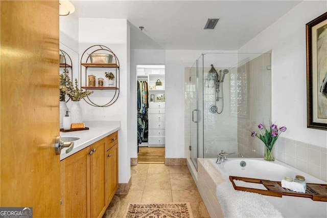 3235 Roswell Rd NE Unit 508, Atlanta, GA 30305 - full bath with a shower stall, vanity, a bath, tile patterned flooring, and a walk in closet