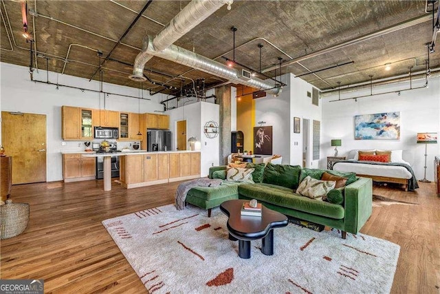 3235 Roswell Rd NE Unit 508, Atlanta, GA 30305 - living room featuring a high ceiling, dark wood-style floors, and rail lighting