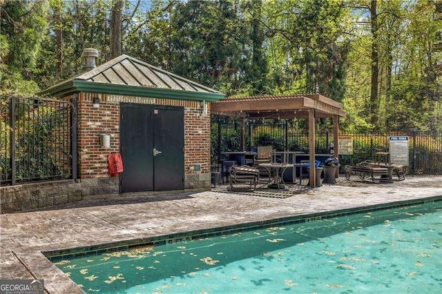 3235 Roswell Rd NE Unit 508, Atlanta, GA 30305 - view of pool featuring a patio, a pergola, and an outdoor structure