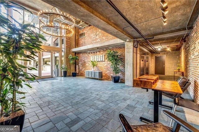 3235 Roswell Rd NE Unit 508, Atlanta, GA 30305 - community lobby featuring brick wall and a towering ceiling