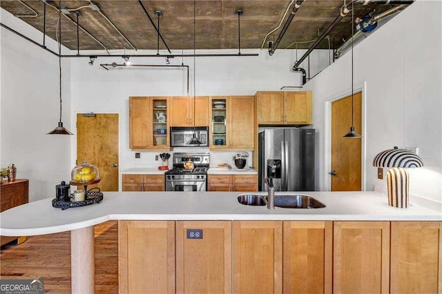 3235 Roswell Rd NE Unit 508, Atlanta, GA 30305 - kitchen featuring stainless steel appliances, a high ceiling, light countertops, glass insert cabinets, and a peninsula