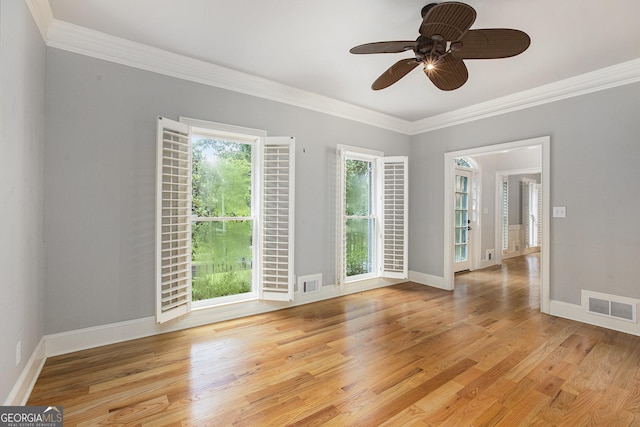 386 Link Rd, Alpharetta, GA 30022 - spare room featuring crown molding, baseboards, light wood-style flooring, and a ceiling fan