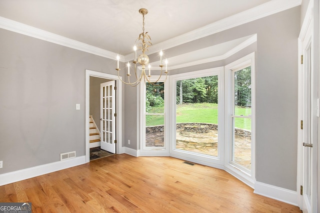 386 Link Rd, Alpharetta, GA 30022 - unfurnished dining area featuring crown molding, baseboards, a chandelier, light wood-style flooring, and stairs