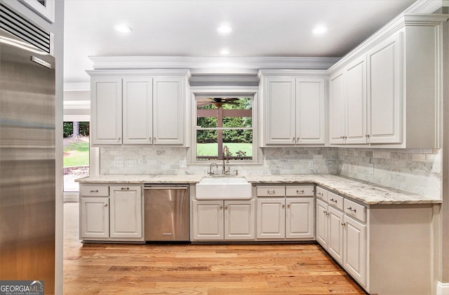 386 Link Rd, Alpharetta, GA 30022 - kitchen featuring stainless steel appliances, a sink, light wood-style flooring, white cabinets, and ornamental molding