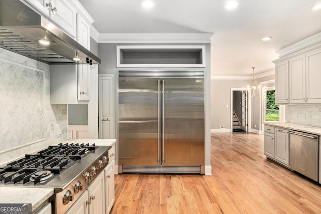 386 Link Rd, Alpharetta, GA 30022 - kitchen featuring stainless steel appliances, exhaust hood, light wood-type flooring, ornamental molding, and decorative backsplash