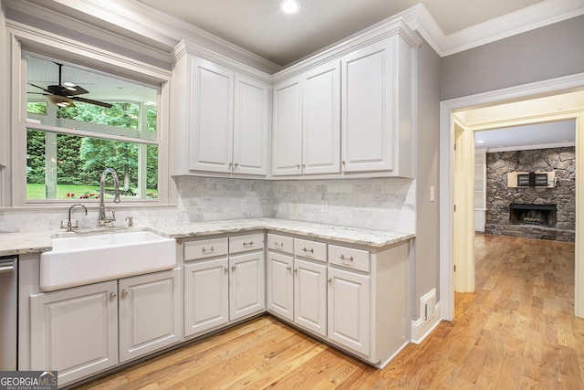 386 Link Rd, Alpharetta, GA 30022 - kitchen with a sink, crown molding, white cabinetry, light wood-style floors, and decorative backsplash